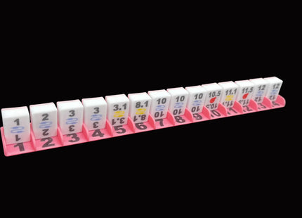 bombbusters mahjong tiles in a pink stand 