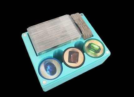 Compact cyan game organizer for splendor with cards and tokens inside