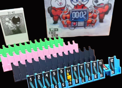 Set of colorful plastic timers on a wooden surface with a cartoon character poster in the background.