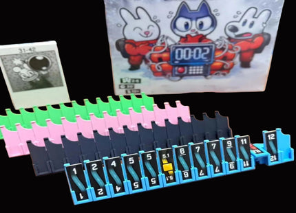 Bomb Busters Player Wire Stands A vintage-style slot machine toy set with a blue numbered slot bar, pink and green pegs, a small card, and a printed package or card featuring cartoon characters and a timer display, shown on a black background.