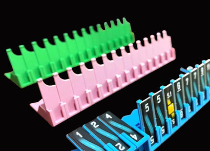 Colorful plastic card holders on a wooden surface with blurred background